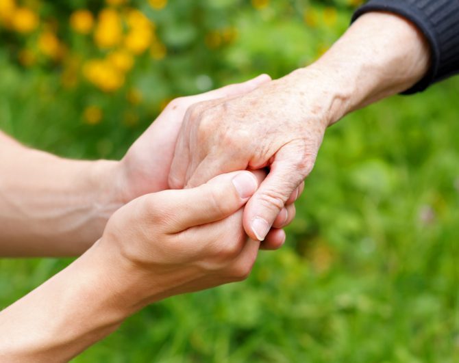 holding hands at assisted living home
